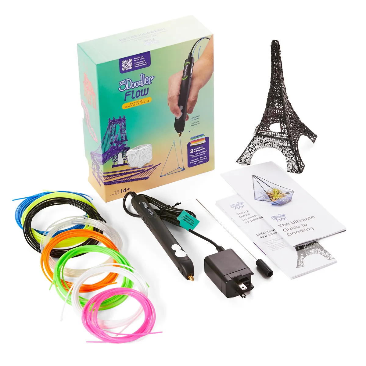 3Doodler Flow 3D printing pen set with box, power adapter, coils of colored filament, a guide and a small 3D-drawn Eiffel Tower