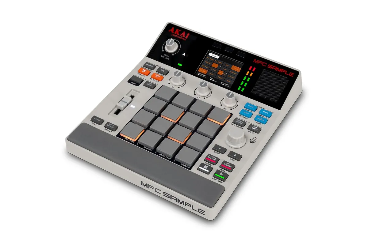 The Akai MPC Sample in grey, seen at an angle with its 16 pads, knobs, fader and screen