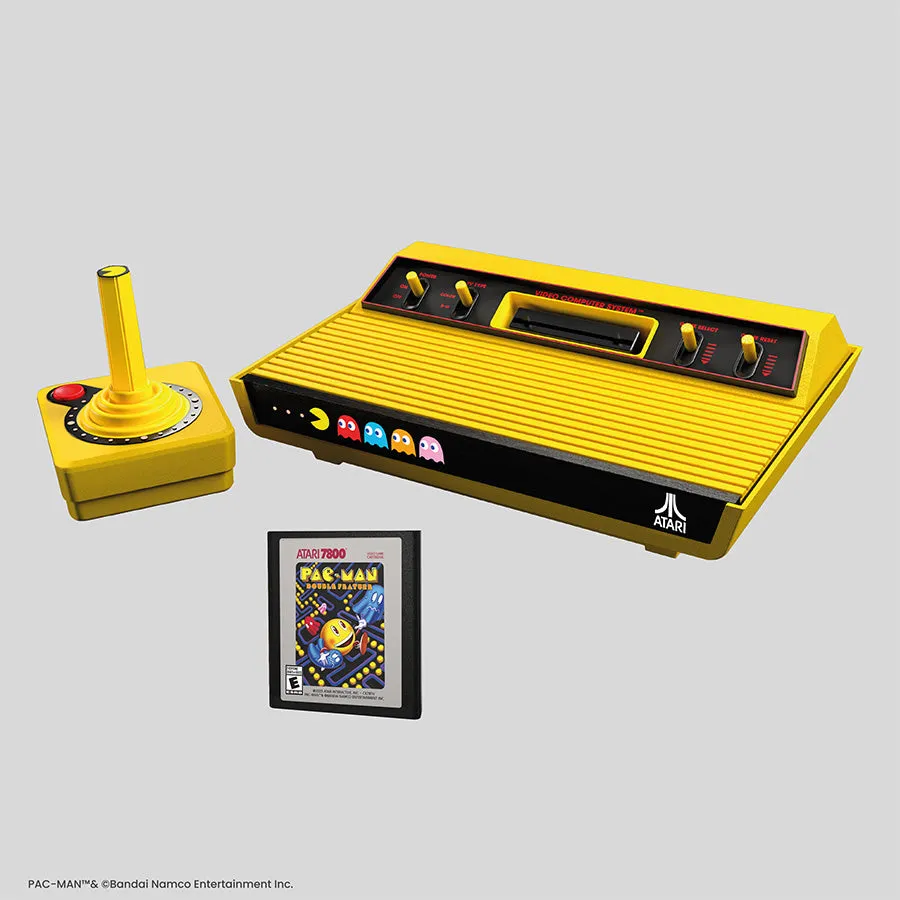Yellow Atari 2600+ PAC-MAN Edition console with its yellow wireless joystick and the PAC-MAN Double Feature cartridge