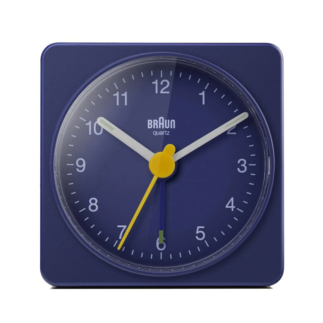 Blue Braun BC02 analog travel alarm clock with a yellow second hand