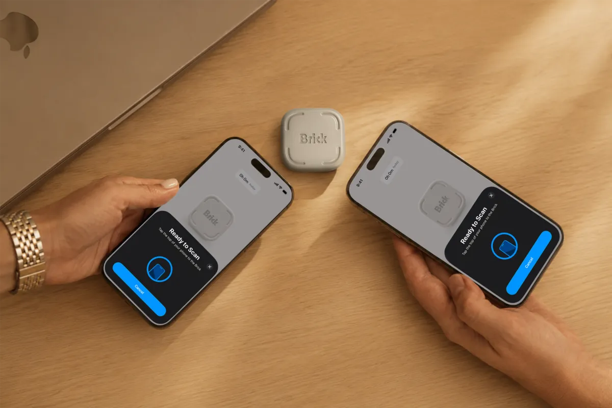 Brick phone blocker on a desk next to two phones