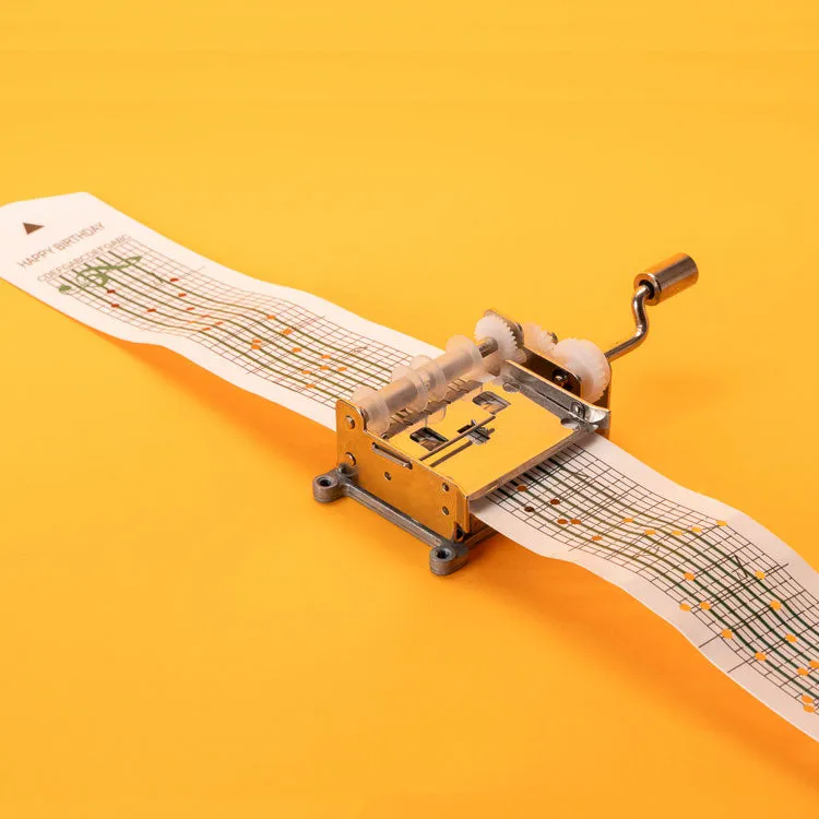 Kikkerland music box kit with paper strips and hole punch