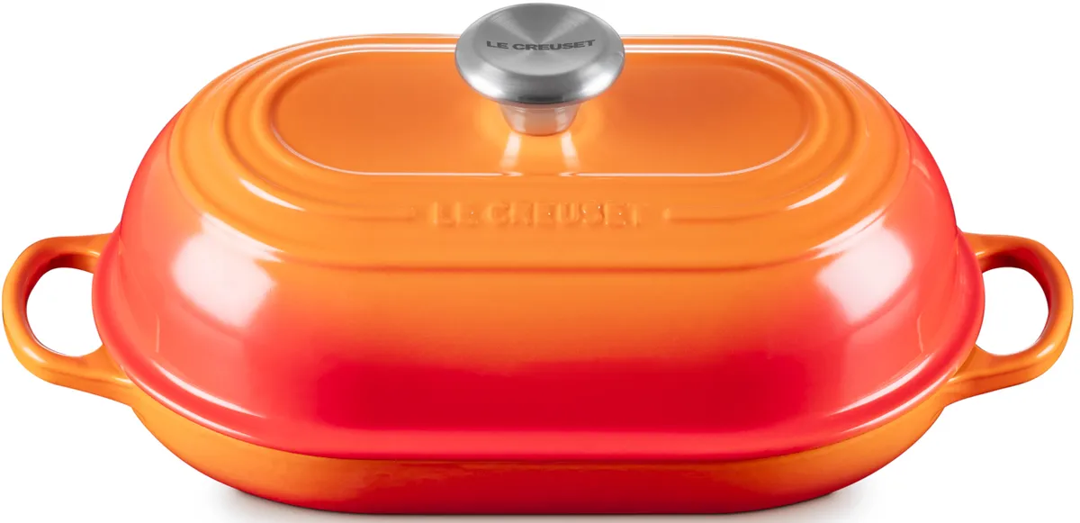 Le Creuset Signature Oval Bread Oven in Flame orange with the lid on, side view