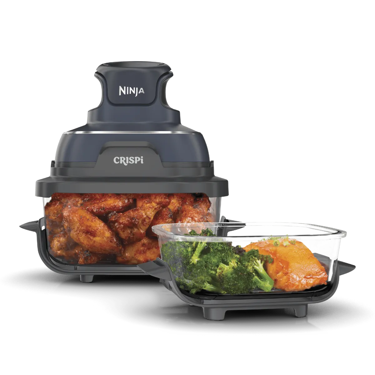 Ninja Crispi glass air fryer with chicken wings in the large container and a smaller container of salmon and broccoli
