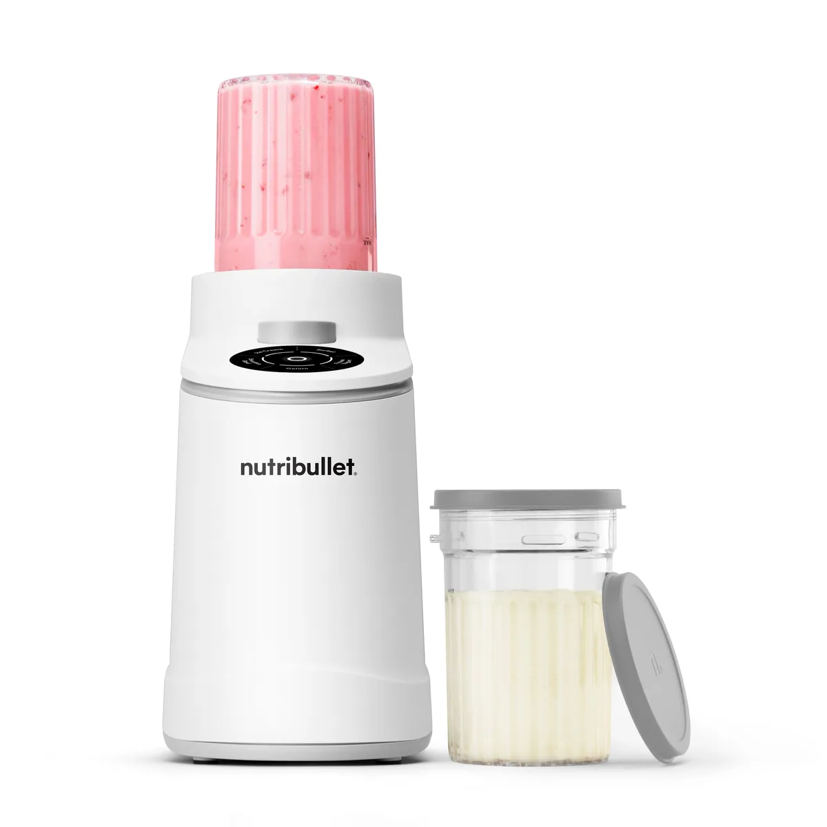 White nutribullet Chill ice cream maker with a pink pint cup on top, next to a second pint cup and lid