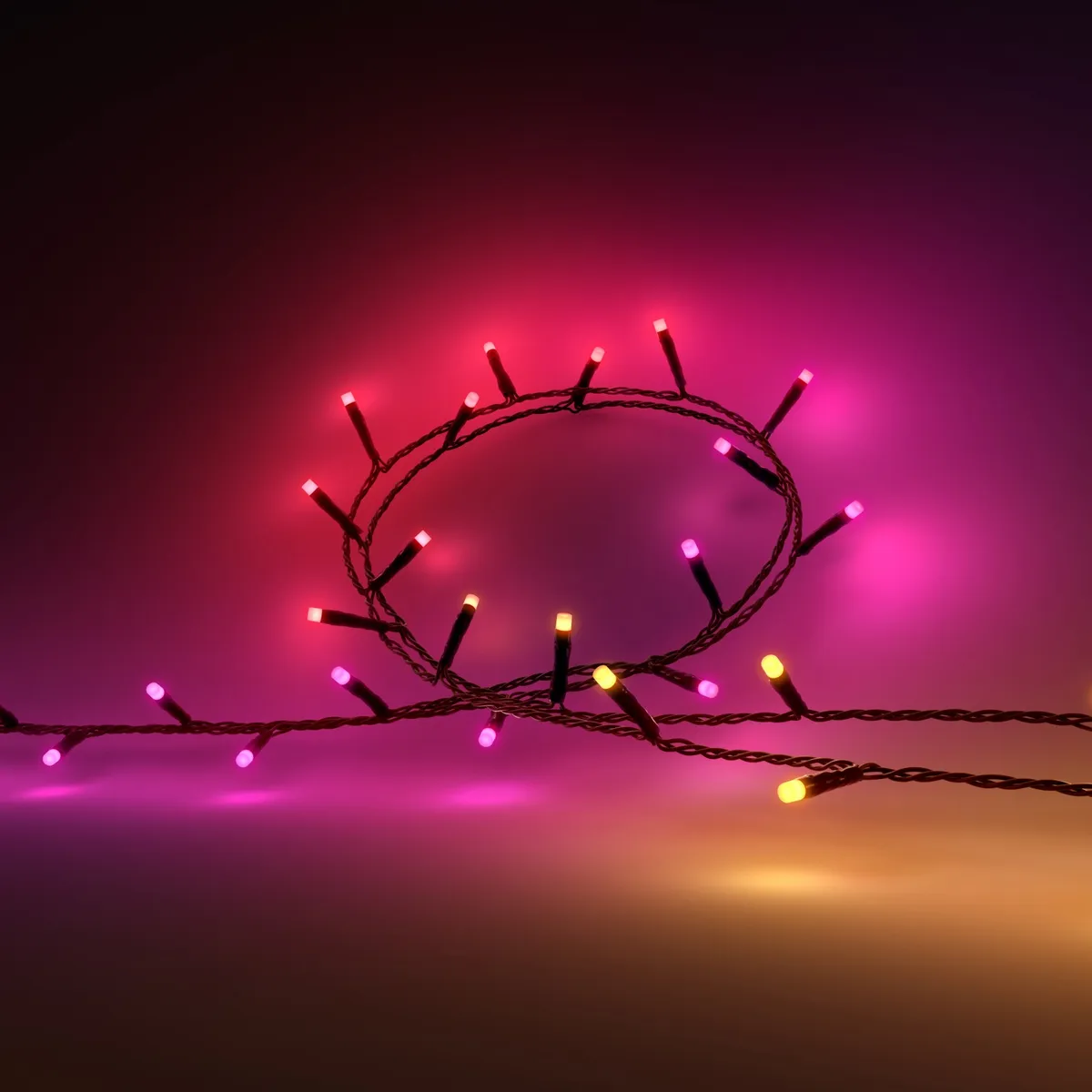 Close-up of Philips Hue Festavia string lights glowing pink, red and yellow