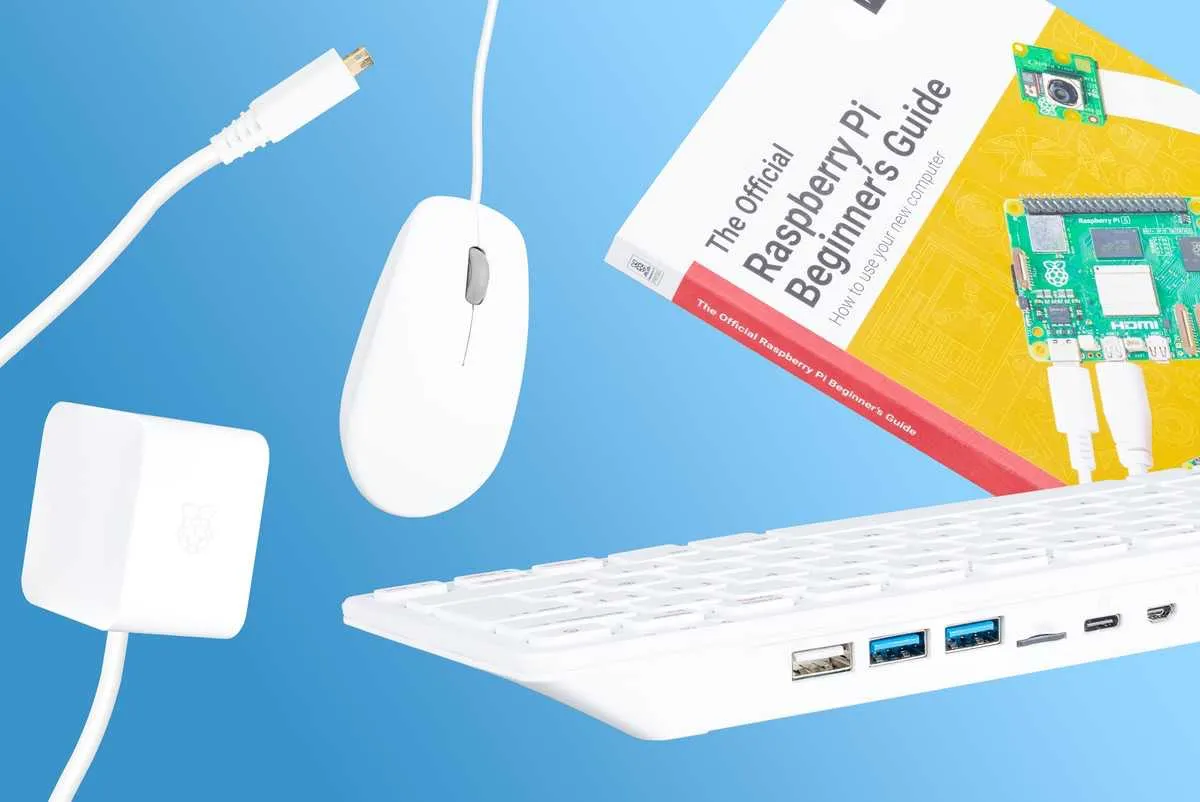 The Raspberry Pi 500 Desktop Kit: a white keyboard computer, mouse, power supply and the Beginner's Guide book