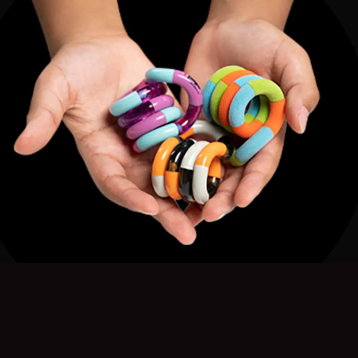 A handful of Tangle Jr. Classic fidget toys