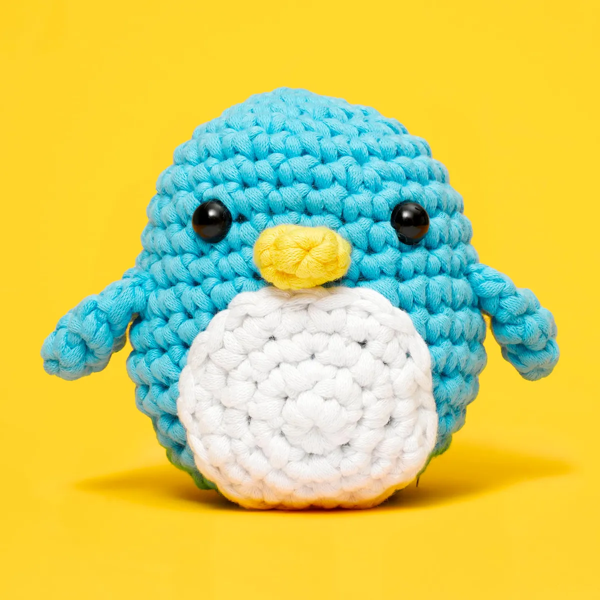 The Woobles Pierre the Penguin, a blue and white crocheted penguin with a yellow beak
